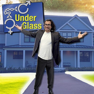 Dark-haired smiling man with arms extended standing in front of a residence with the Under Glass logo next to him